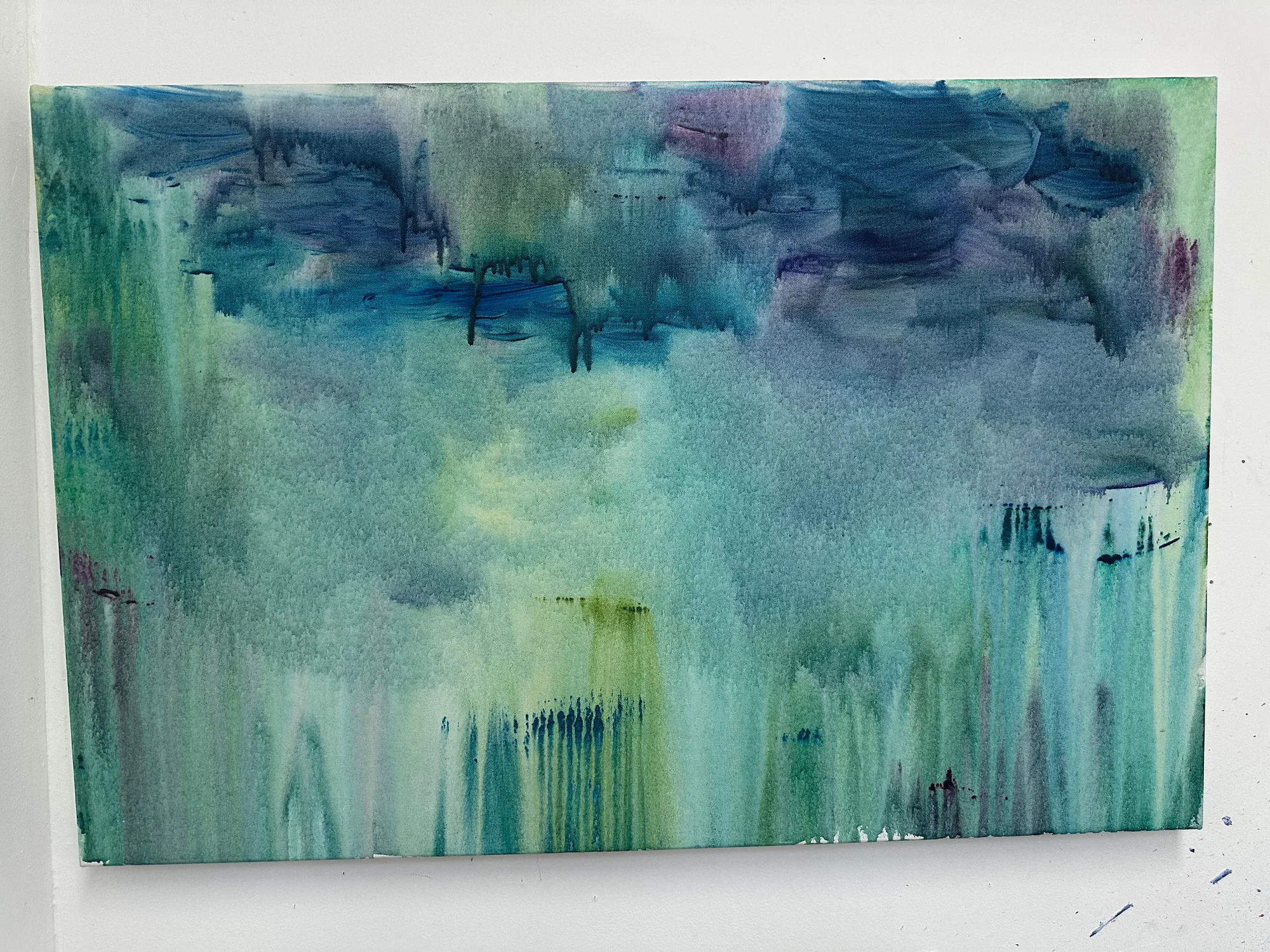 A blue, green and purple acrylic painting with drips and more distinct strokes at the top, and a wash at the bottom.