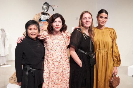 Four women standing with a fashion mannequin in the background