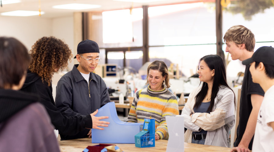 A Product Design instructor demonstrates a project to 6 students