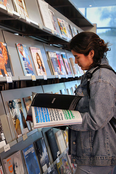 Student reading a magazine in Otis Library