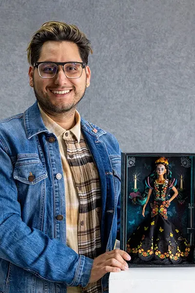 Javier Meabe (’12 BFA Toy Design) with one of his Dia de los Muertos Barbie dolls. Photograph by Danielle Vega/Otis College of Art and Design. 