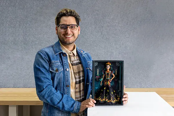 Javier Meabe (’12 BFA Toy Design) with one of his Dia de los Muertos Barbie dolls. Photograph by Danielle Vega/Otis College of Art and Design. 