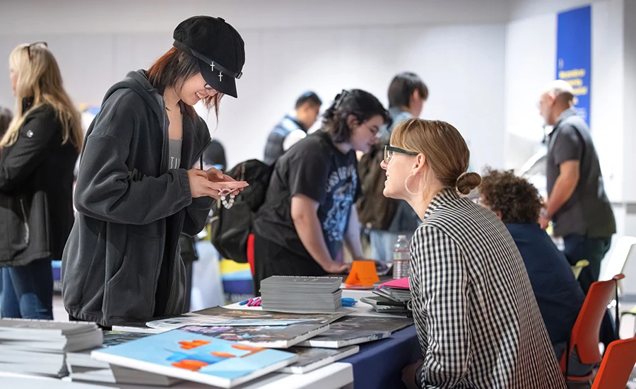 Executive Director of Admissions Pathways Courtney Richter advises a student during a National Portfolio Day event held at Otis College.