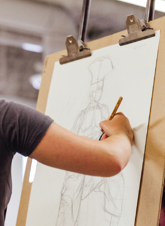 Otis Extension student drawing at an easel
