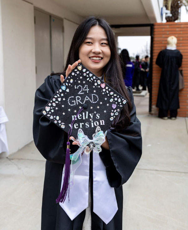 Nelly Le shows off the mortarboard she decorated for her graduation ceremony in May 2024. Photograph by Danielle Vega/Otis College of Art and Design