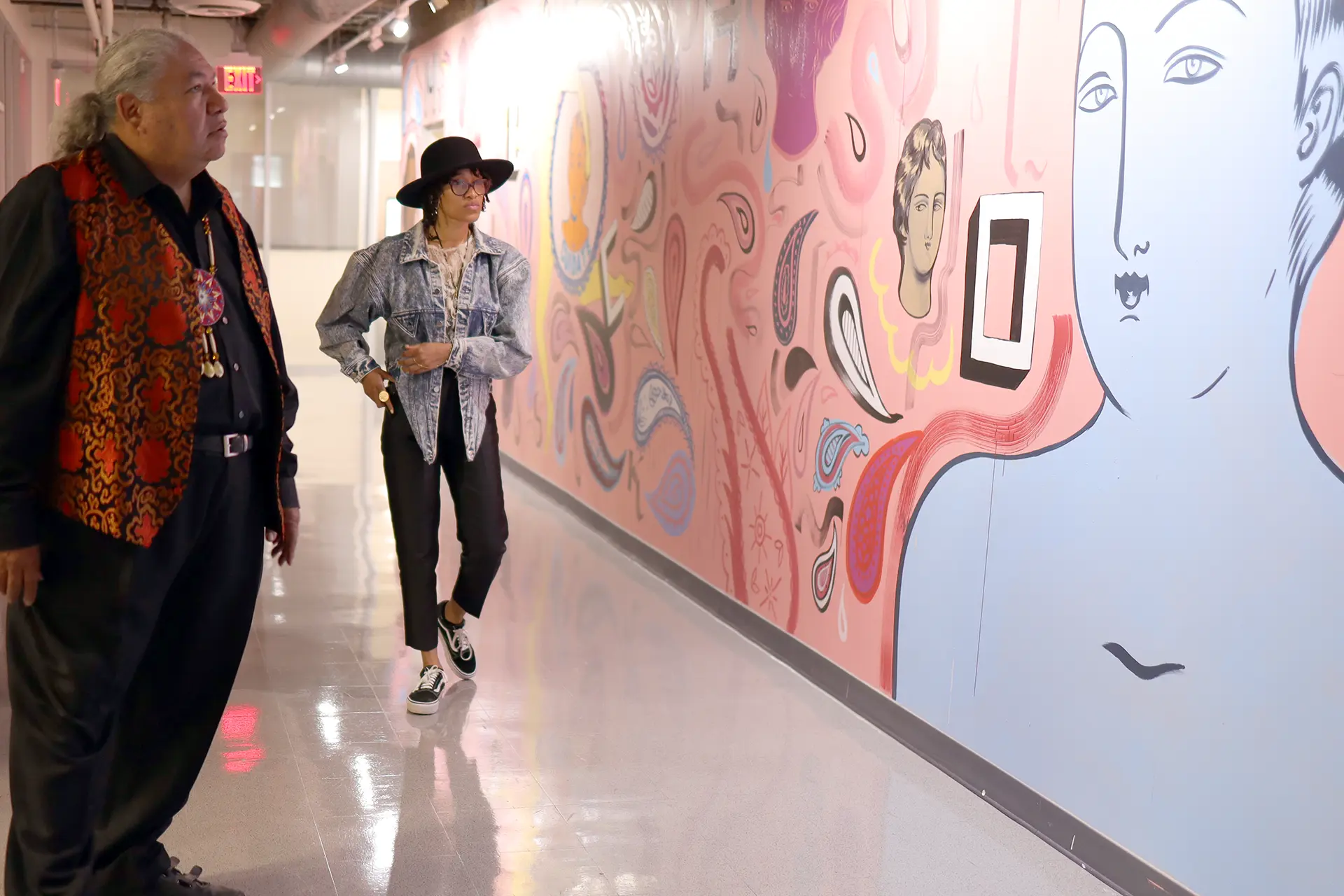 Edgar Heap of Birds admiring a mural at Otis College