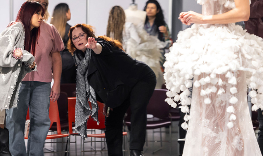 Fashion Design mentor Patricia DeLaunay (’04 BFA Fashion Design), center, during a fitting. Photograph by Danielle Vega/Otis College of Art and Design.