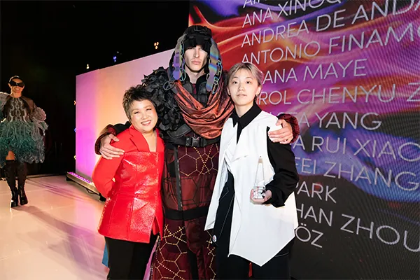 Otis College Fashion Design Chair Jill Zeleznik with Designer of the Year Wirt Li (far right) and a model wearing Li's work.