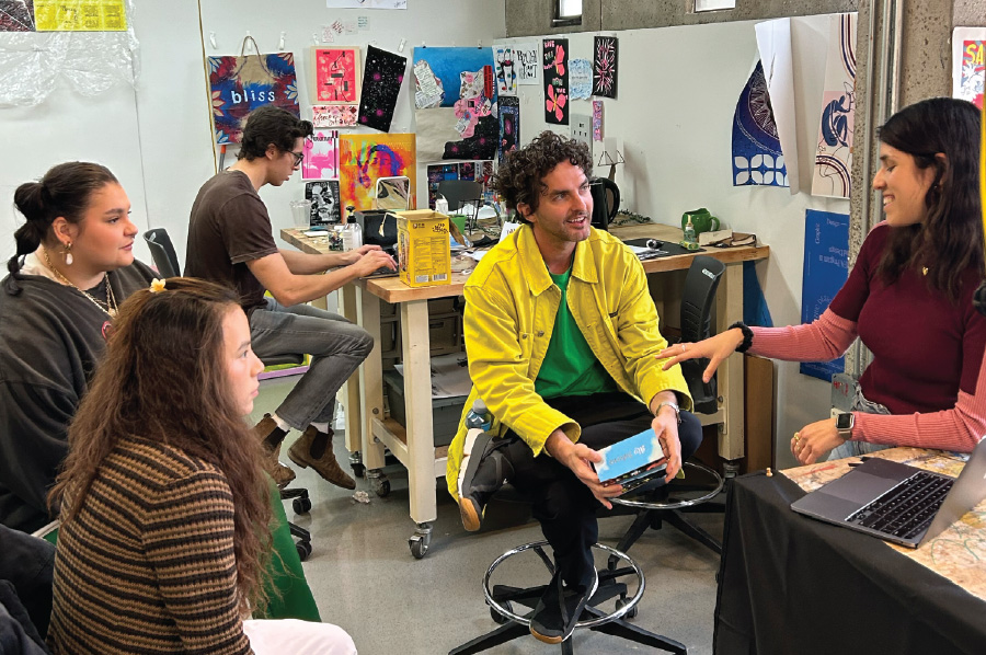 Garrett Fuselier, center, augmented reality lead at TikTok, works with Otis students.