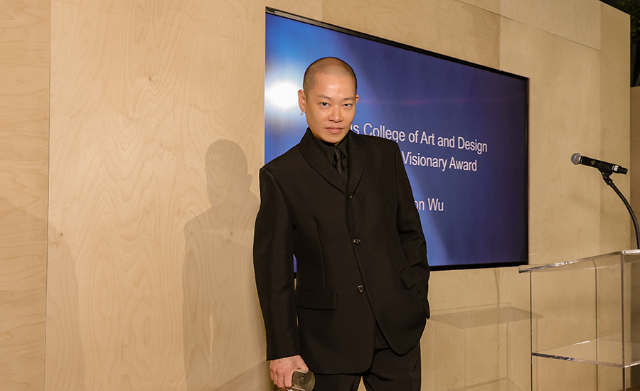 Fashion designer Jason Wu stands with the Creative Visionary Award from Otis College of Art and Design.