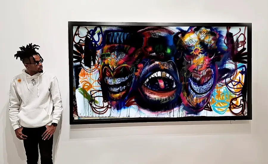 Olivier Ganthier with a work from his MFA thesis exhibition