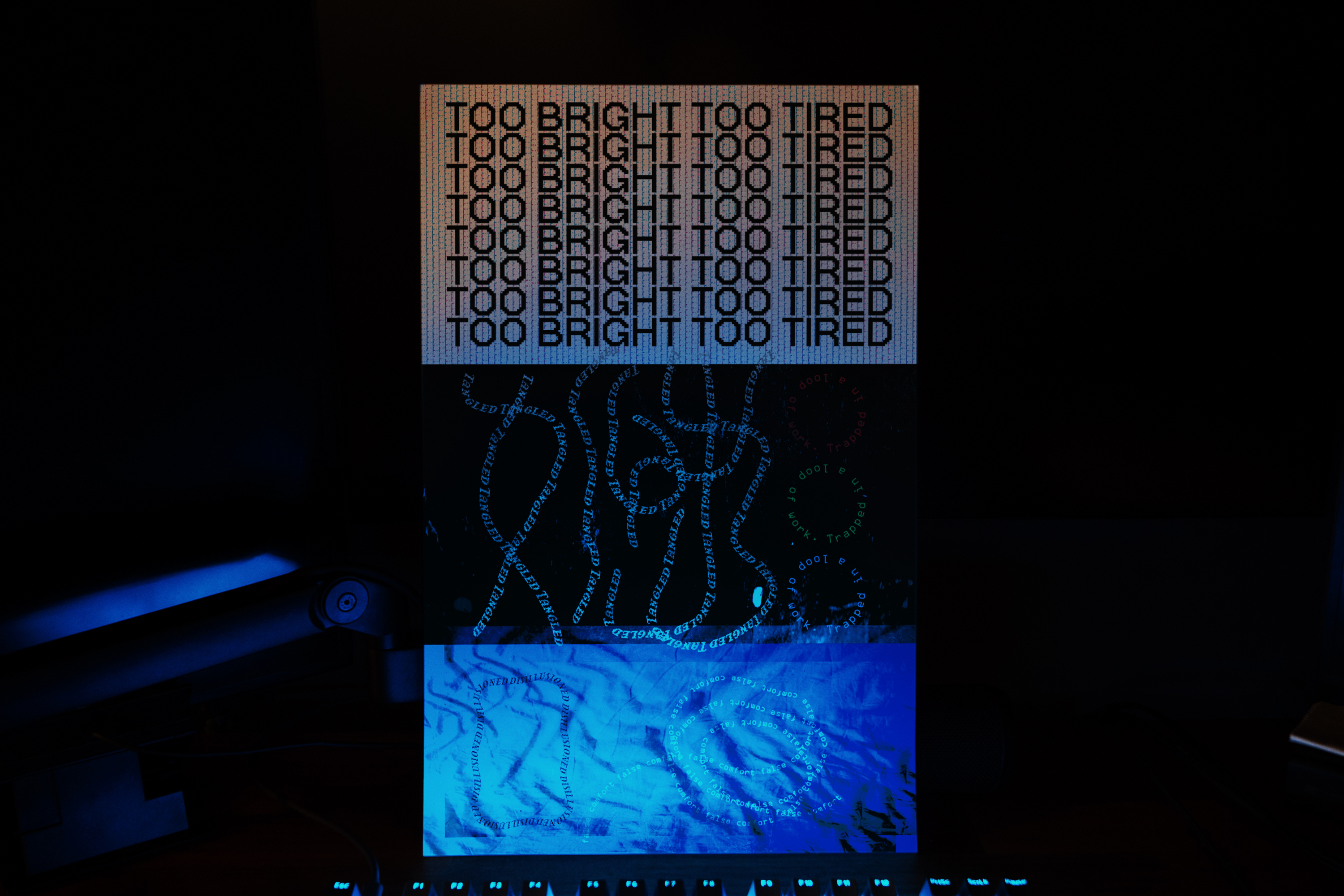 Poster on a desk in a dimly lit room with a small blue light