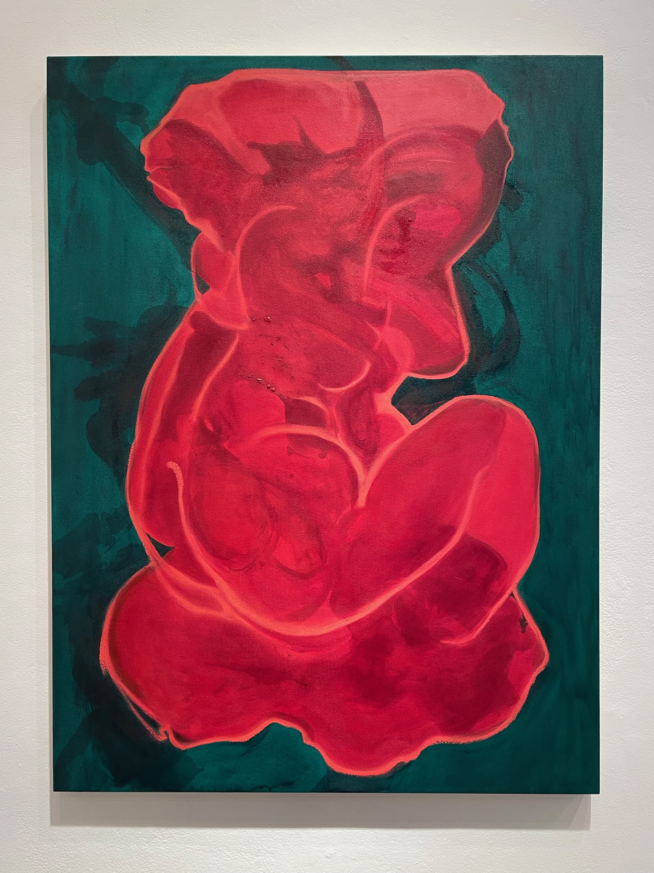 vertical rectange painting of an abstracted reddish figure on an emerald green background
