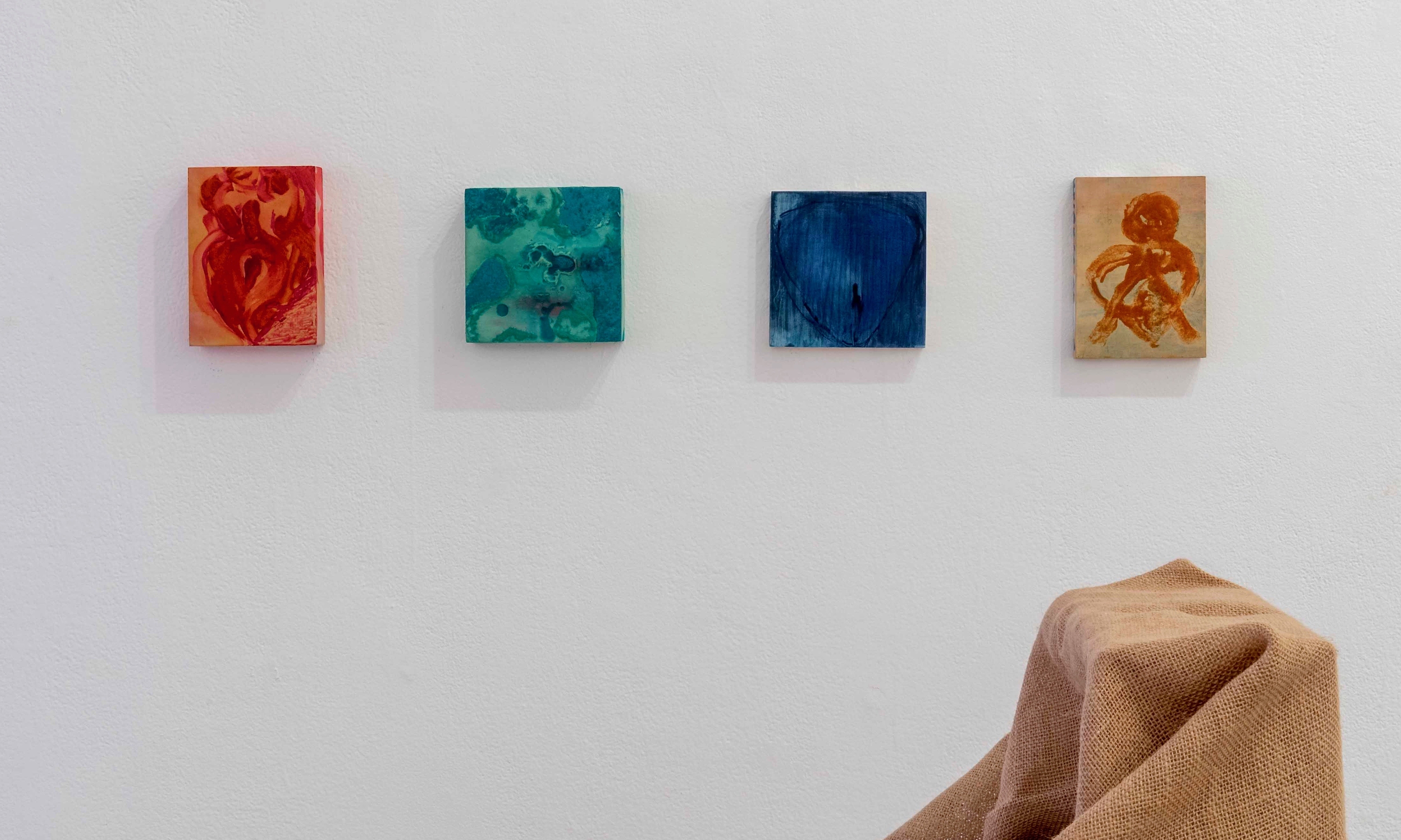 Installation view of four small paintings