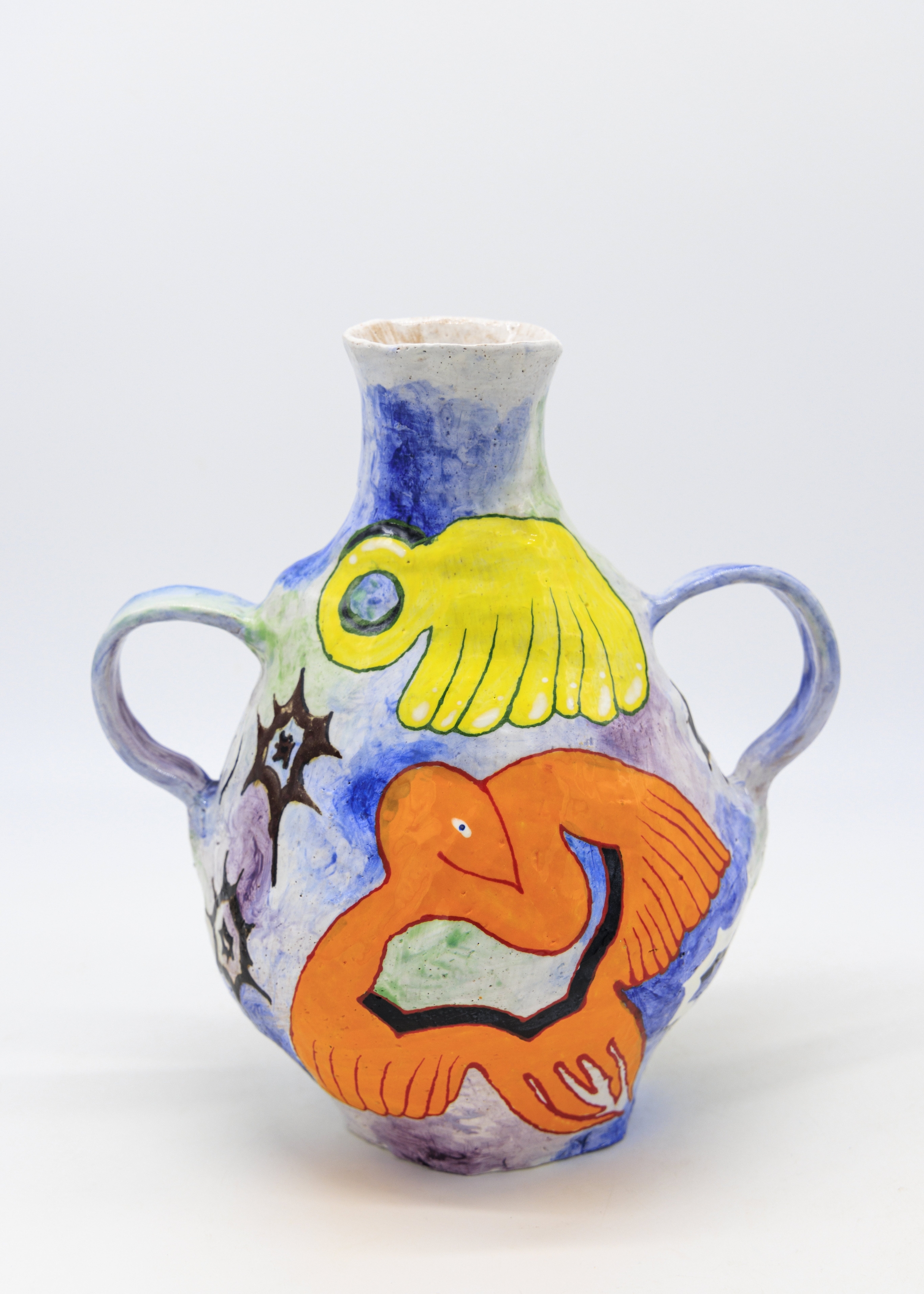ceramic vase with a hollow orange bird and yellow amorphous shape on a blue background.