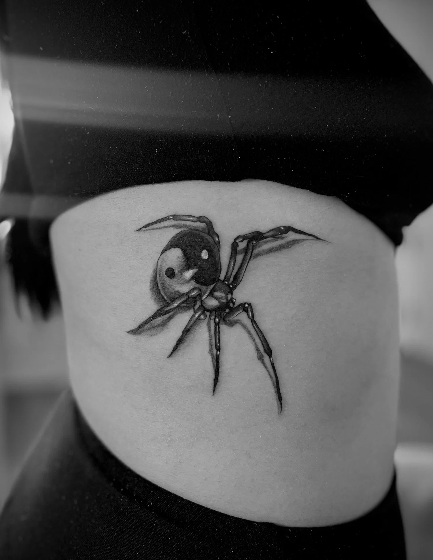 Spider tattoo on the right side of the ribs 