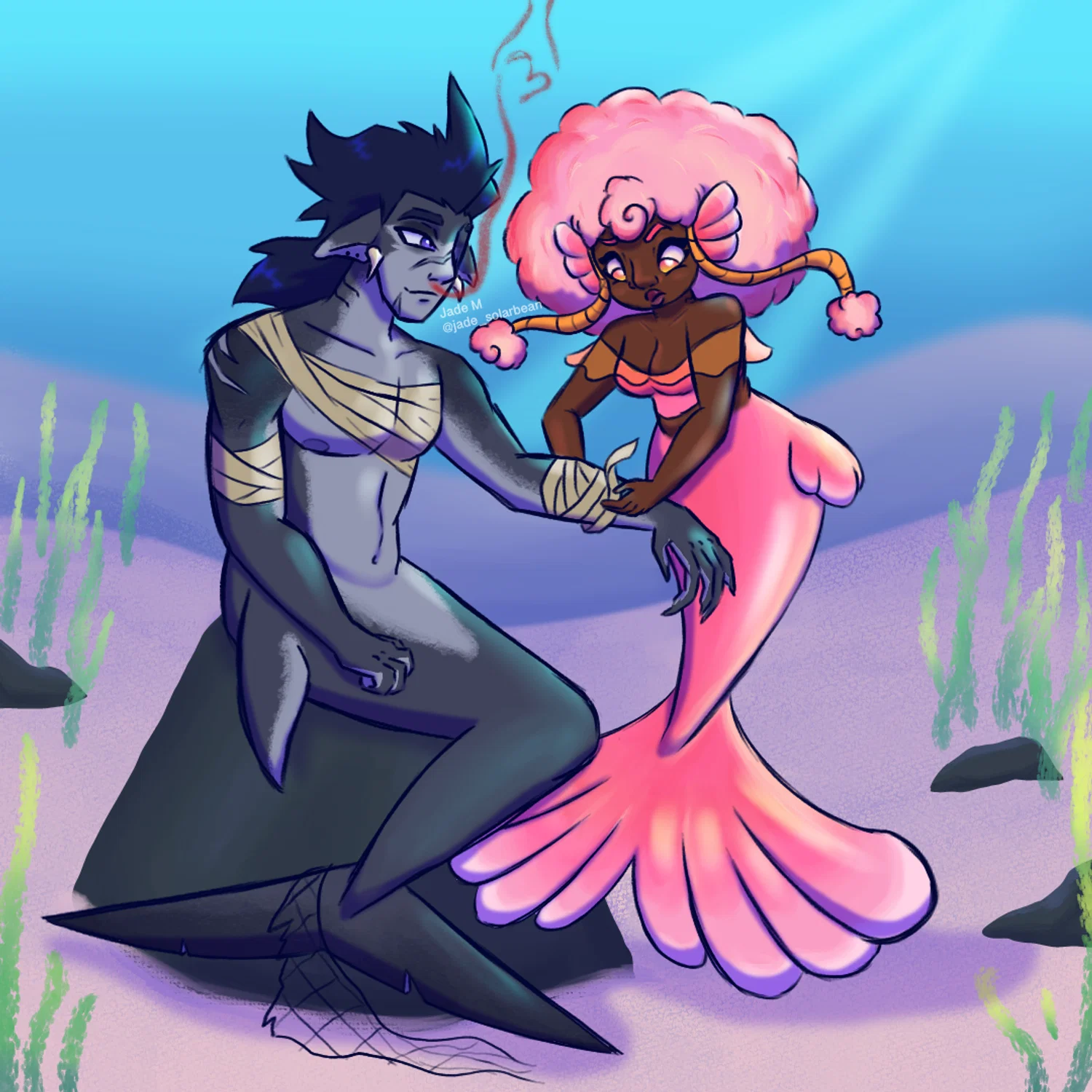 A shark merman sitting on a rock with a pink mermaid bandaging his arm.