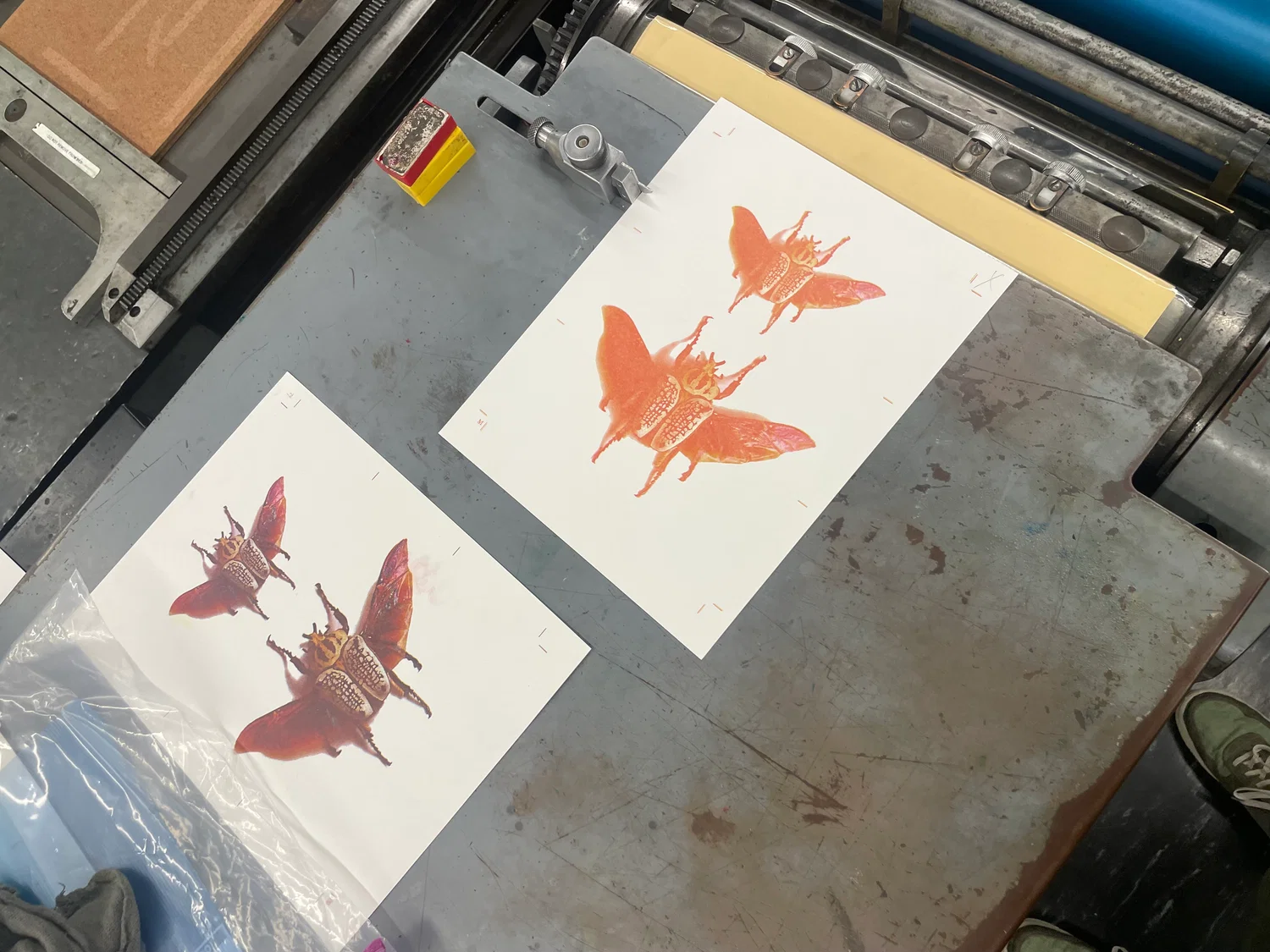 At the letterpress, showing a print in progress next to a finished print