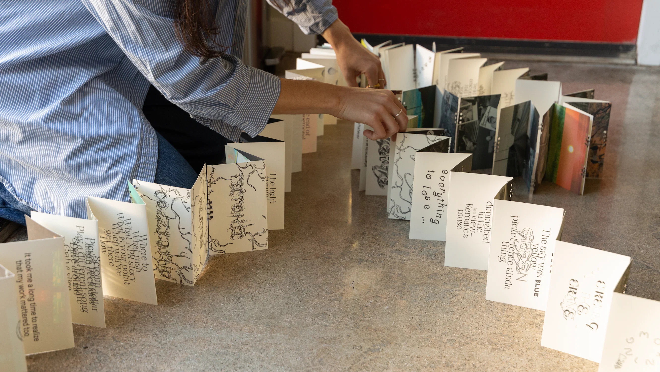 A long accordion book with expressive typography on the pages