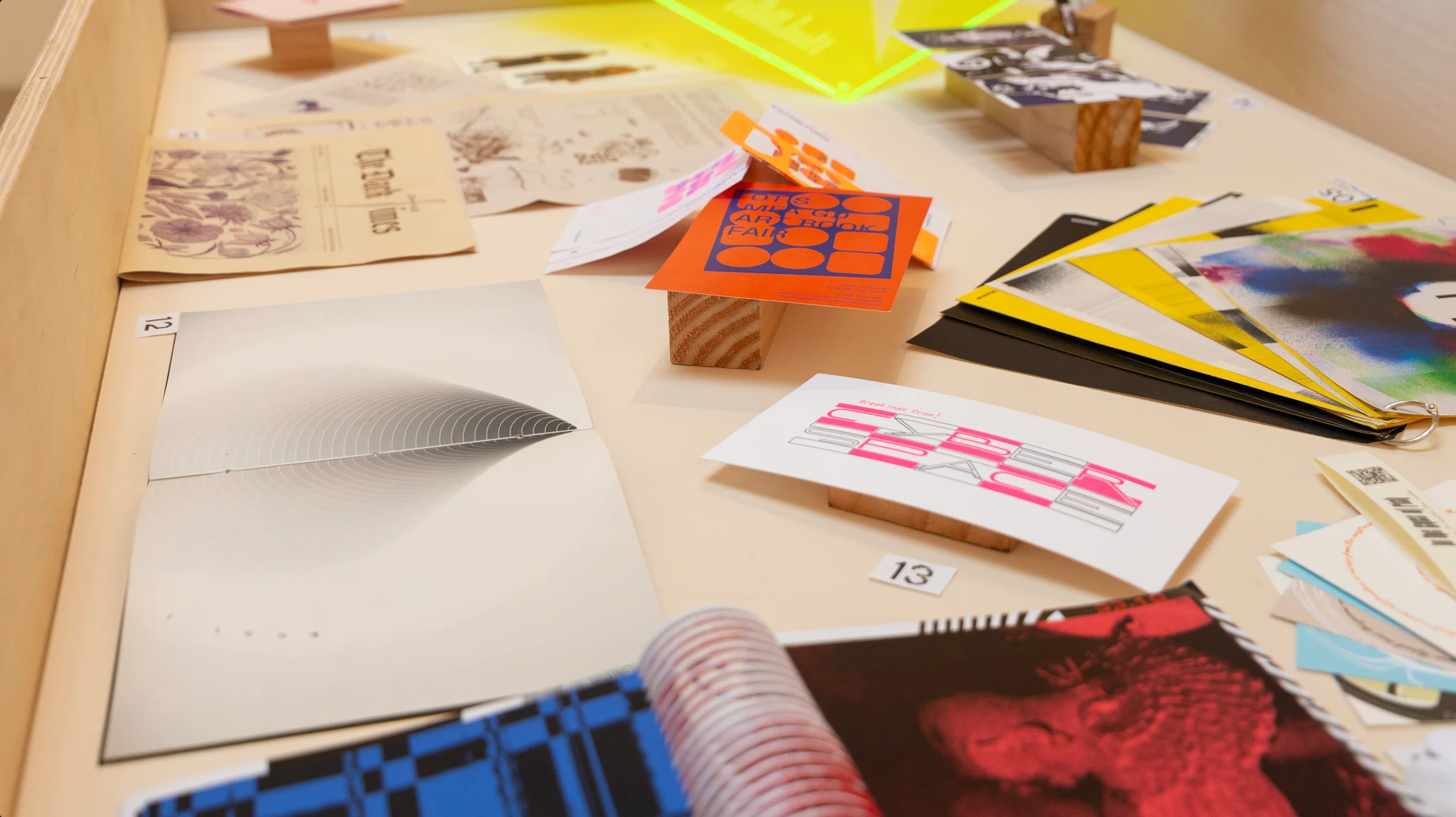 Display case featuring a mix of Graphic Design projects, from books to zines and prints.