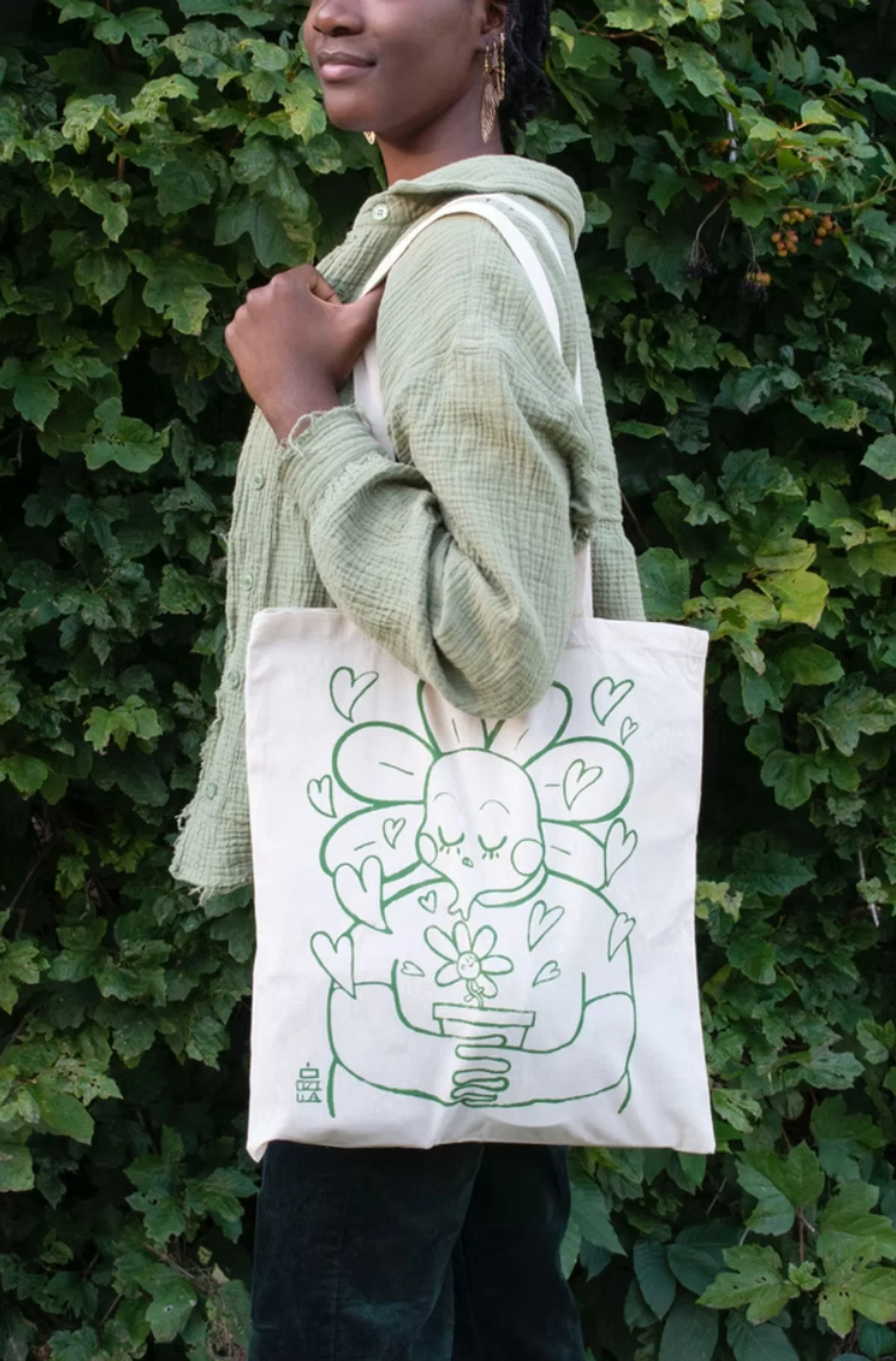 Woman modeling a screen printed tote bag.