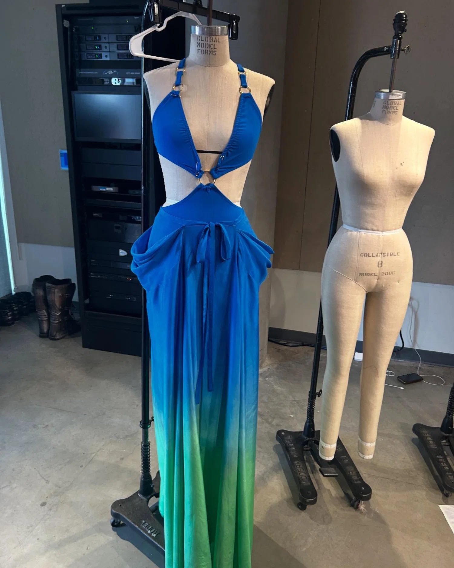 Image of a mannequin with a dress on it with a dip dye coverup on it.
