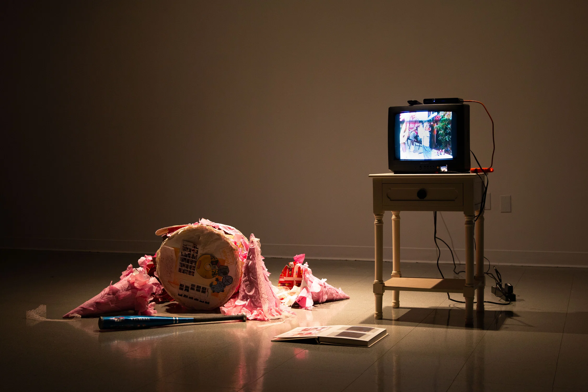 Installation of the artist’s childhood piñata and homemade video.