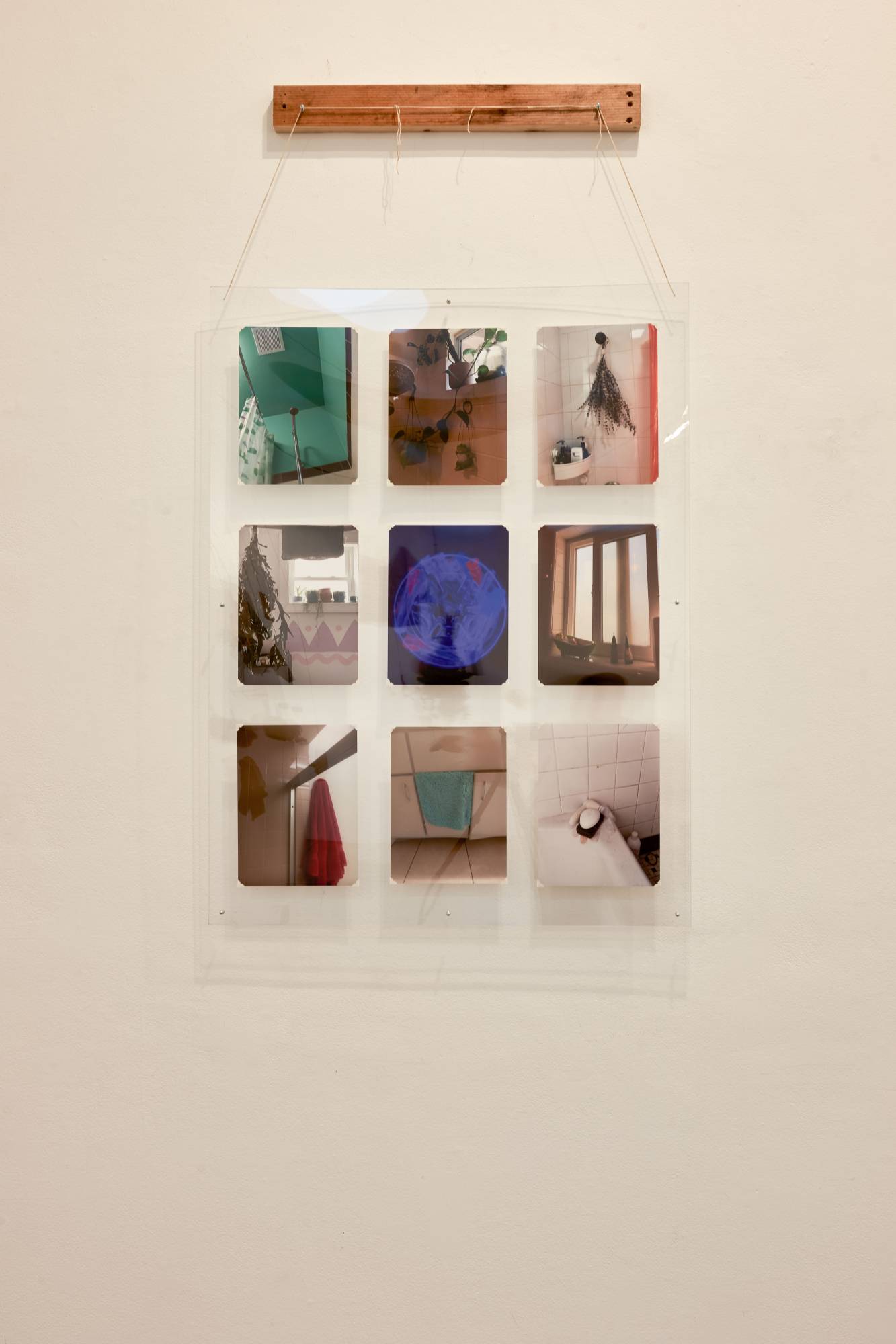 Leo Alas: Community Archive, 2022, 3' x 4' photos from loved ones in plexiglass