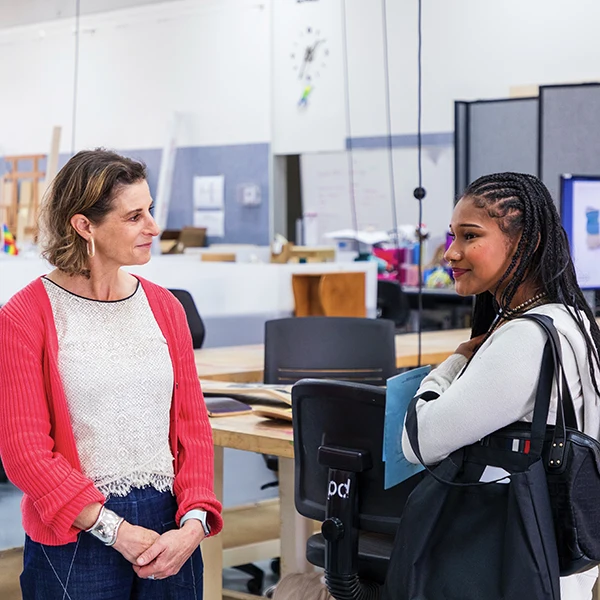 Student and administrator in combuter lab