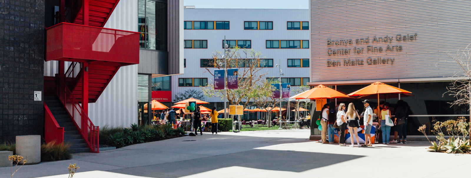 Students walking on campus during sunny day outside