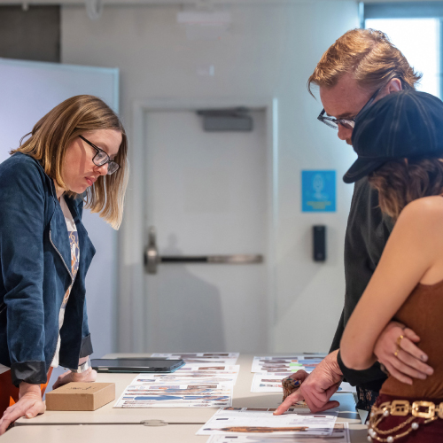 Fashion design students at table