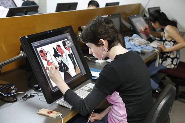 Student doing graphic design in a lab