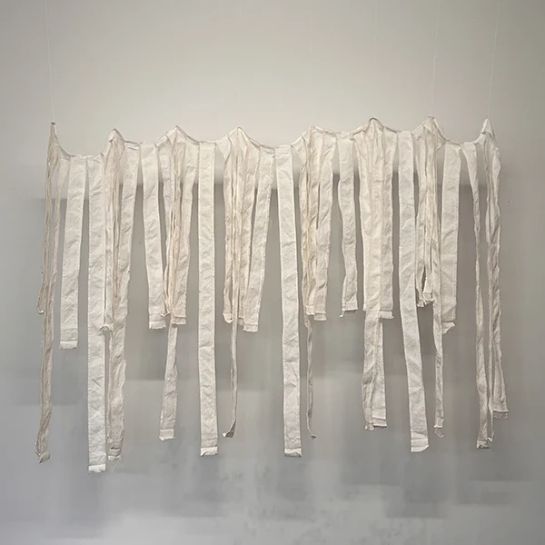 Joy Is an Act of Resistance, 2024, white stripes from deconstructed American Flags with thread and embroidery floss.