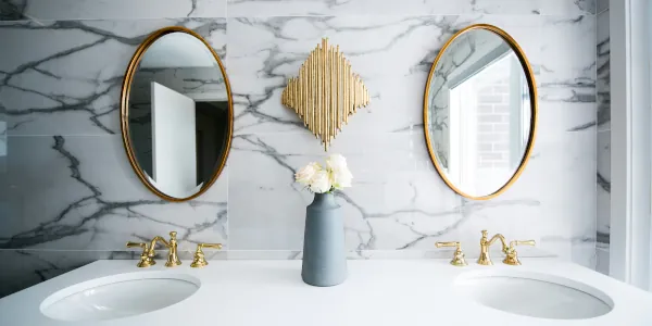 A bathroom vanity with two sinks and two mirrors