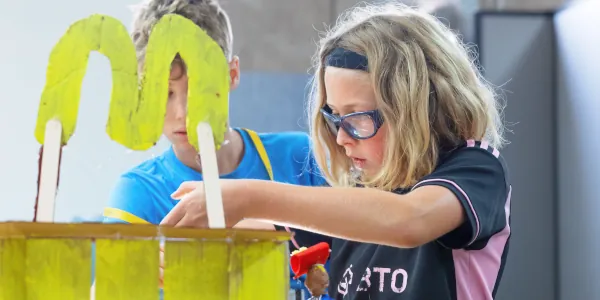 Two Summer Youth Camp students work on a diorama