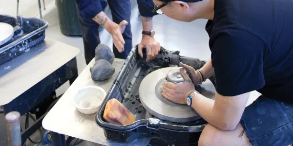 Ceramics student working at a pottery wheel