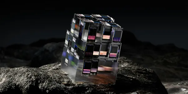 A computer generated image of a cube made u of smaller cubes and sitting on a rock