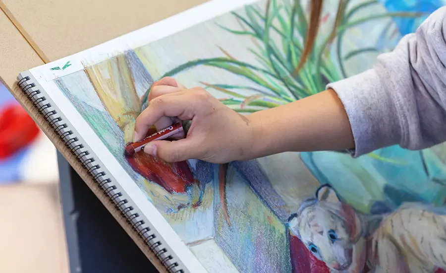 Student drawing with colors in Summer of Art course