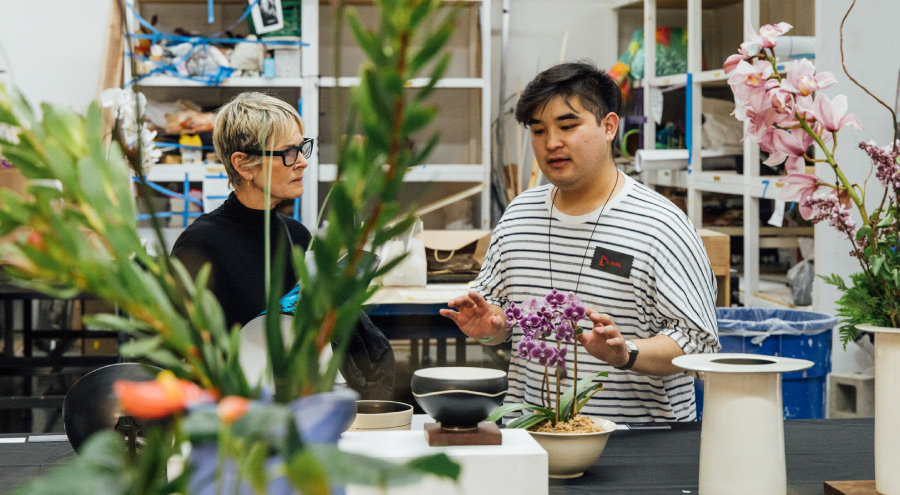 Student and ceramics student talking together in the studio