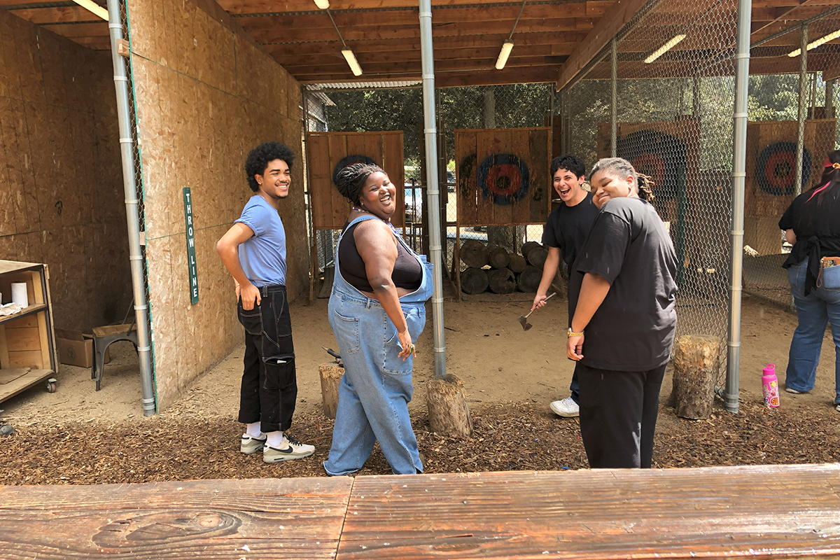 Students at an axe throwing lane