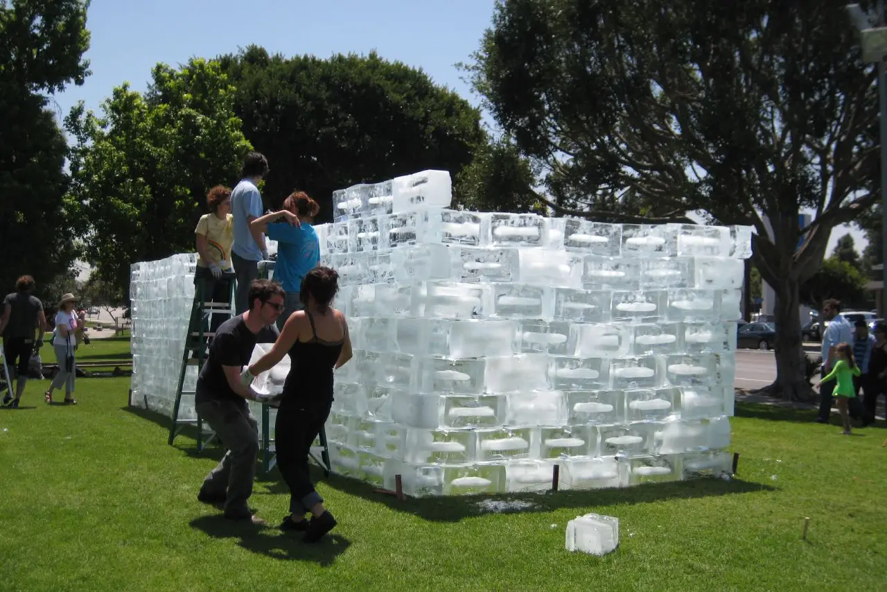 People working on a giant ice sculpture