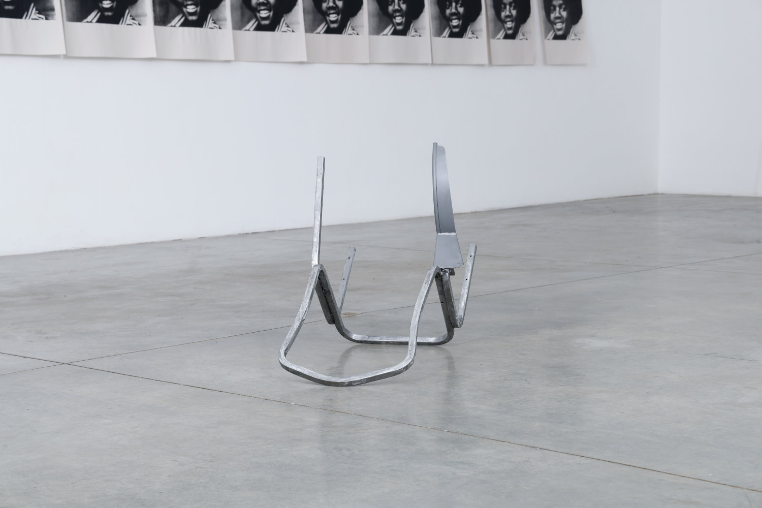 Joseph  Sherman artwork: Upside down broken chair with one  leg  replaced by part of a basketball hoop