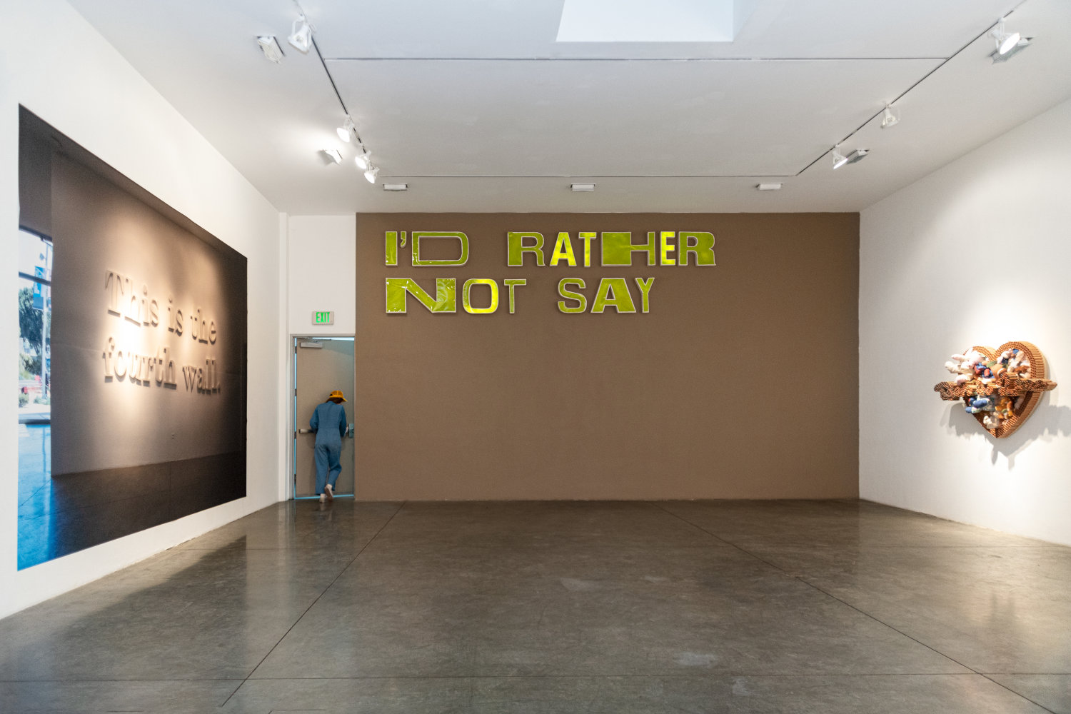Sayer Delk artwork of letters on a wall saying "I'd rather not say" plus other artwork