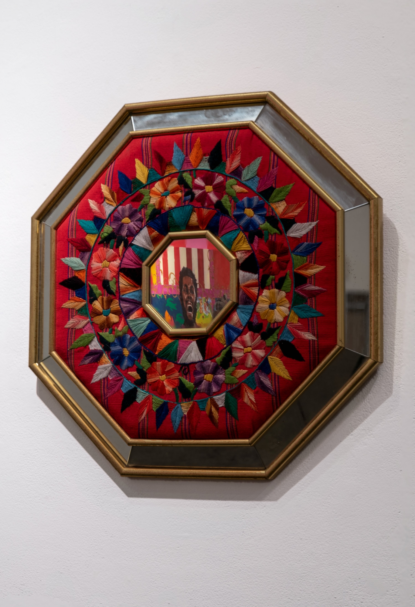 Dani Iribe artwork:  Circles of leavesand flowers around a octongal frame of man's head