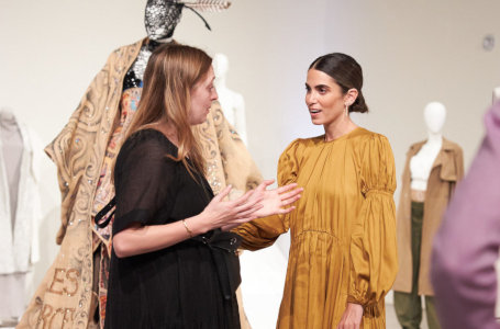 Two women talking at a fashion installation