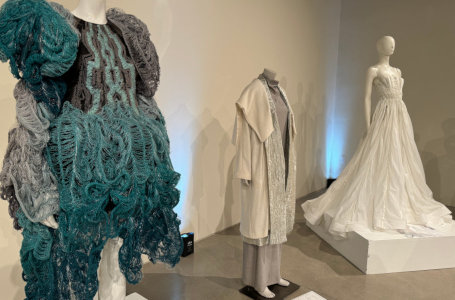Three fashion mannequins wearing various garments