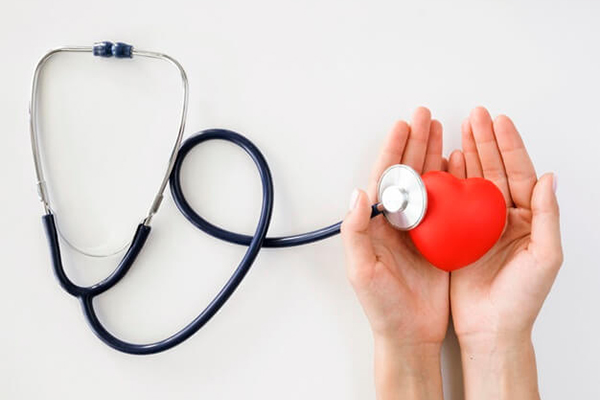 Stethoscope with heart in hands