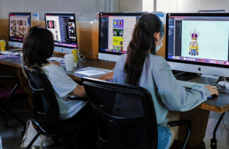 Two students working at computers in a compute lab