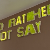 Sayer Delk artwork of letters on a wall saying "I'd rather not say"
