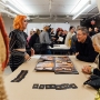 A Fashion Design student shows their portfolio to guests during O-Launch.